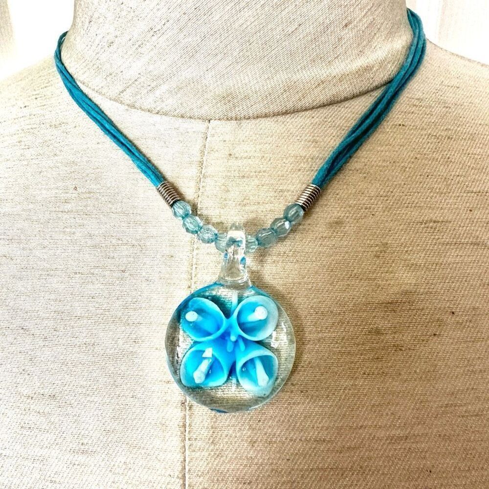 Blue flower glass pendant necklace on blue cord
